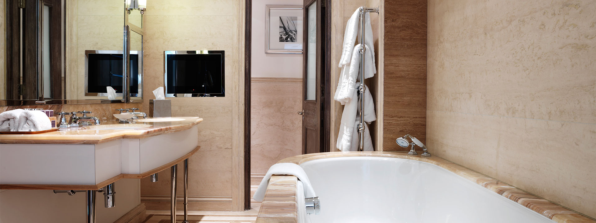 Details from marble bathroom with double bath and in-built TV The Prince's Lodge in The Connaught.